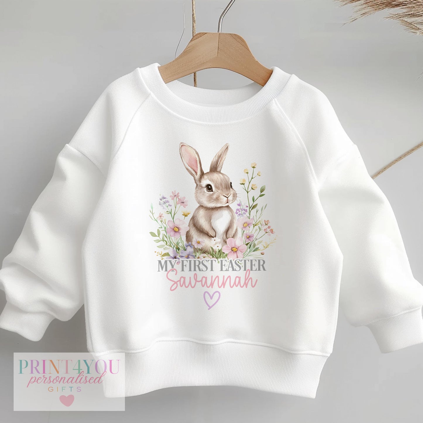 Personalised children's Easter jumper sweatshirt with a floral bunny rabbit design, shown personalised with a name
