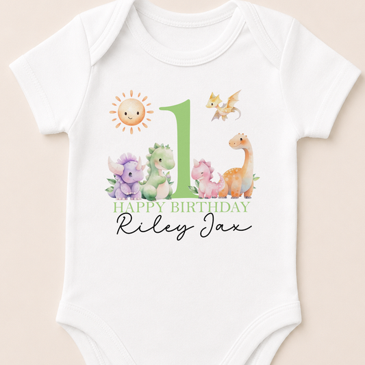Personalised Green Dinosaur first birthday onesie, printed with sun, dragon and dinosaur illustrations and your child's name.