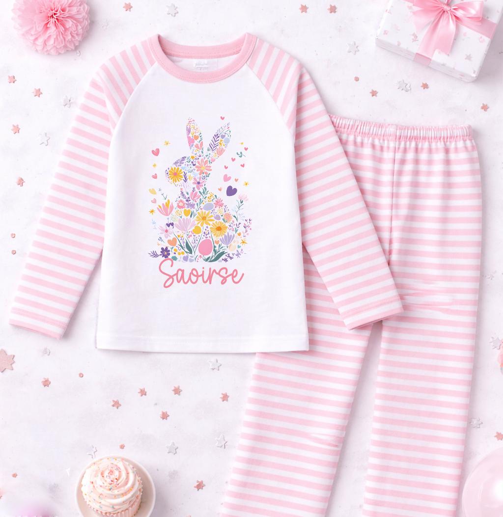 Close-up of the floral bunny motif and personalised name printed on the pink stripe pyjama top