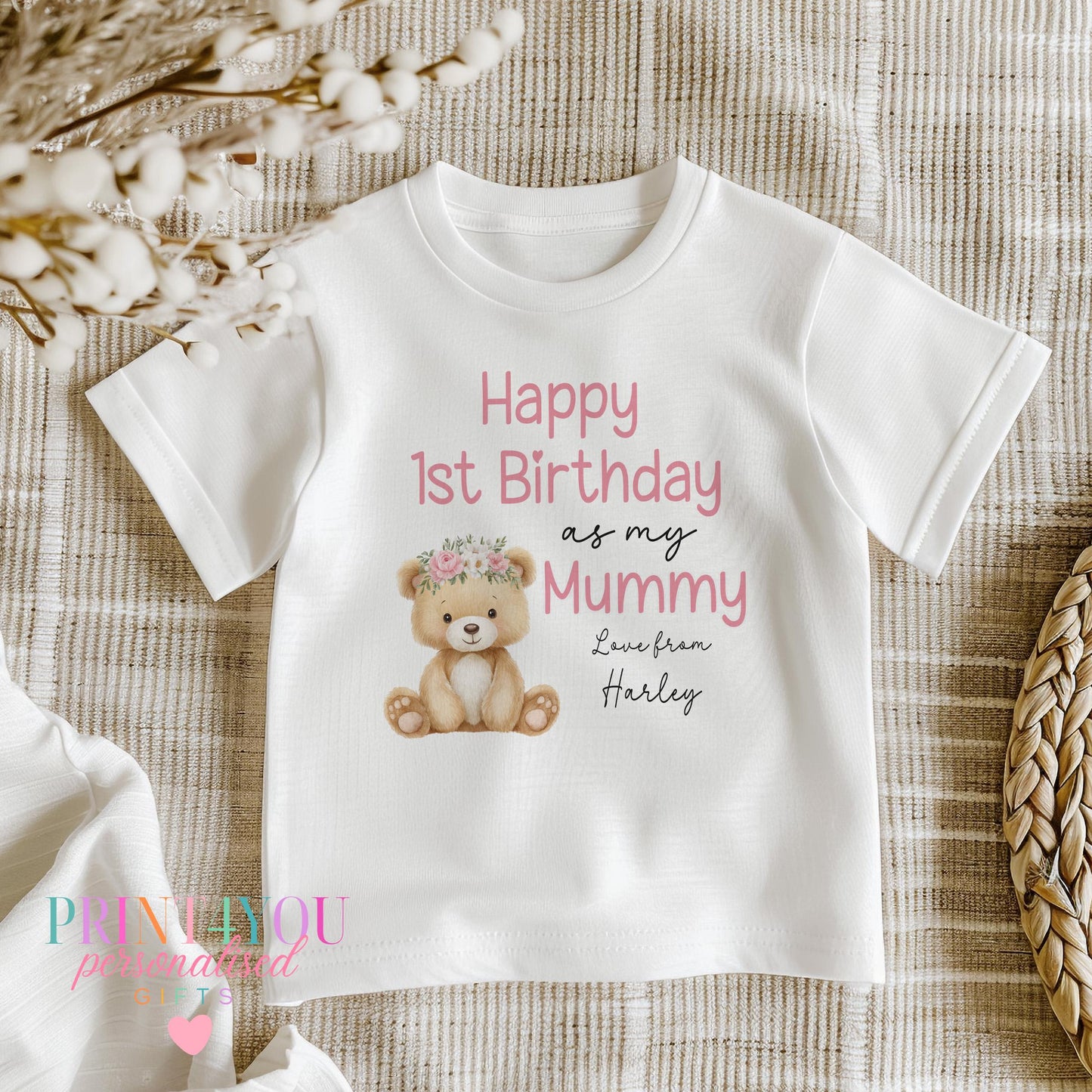 Baby wearing the personalised 'Happy 1st Birthday as my Mummy' sleepsuit with a custom name printed underneath