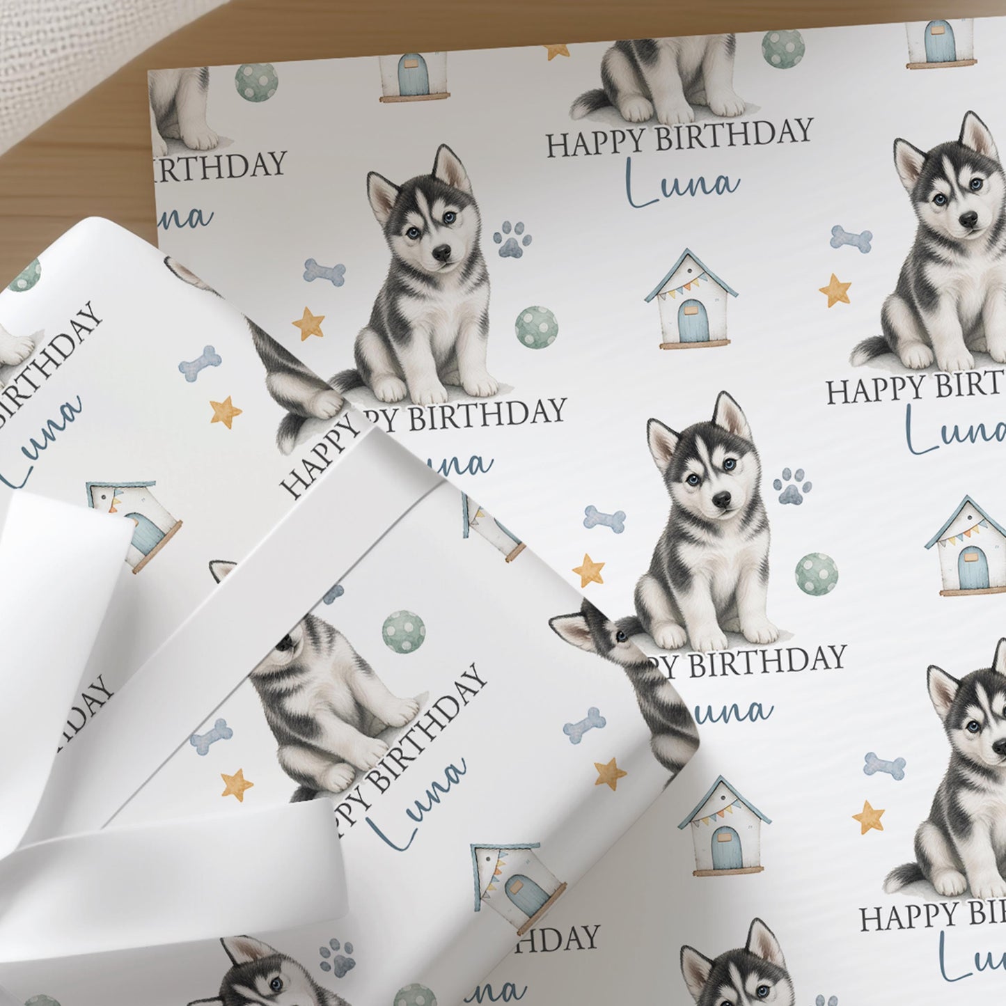 Personalised Husky wrapping paper sheet laid flat showing the full repeating husky puppy and paw print pattern with name.