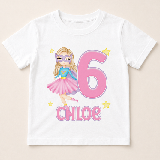A white t-shirt with a graphic design featuring a cartoon girl wearing a superhero costume and the number 6, along with the name " Chloe" written below.