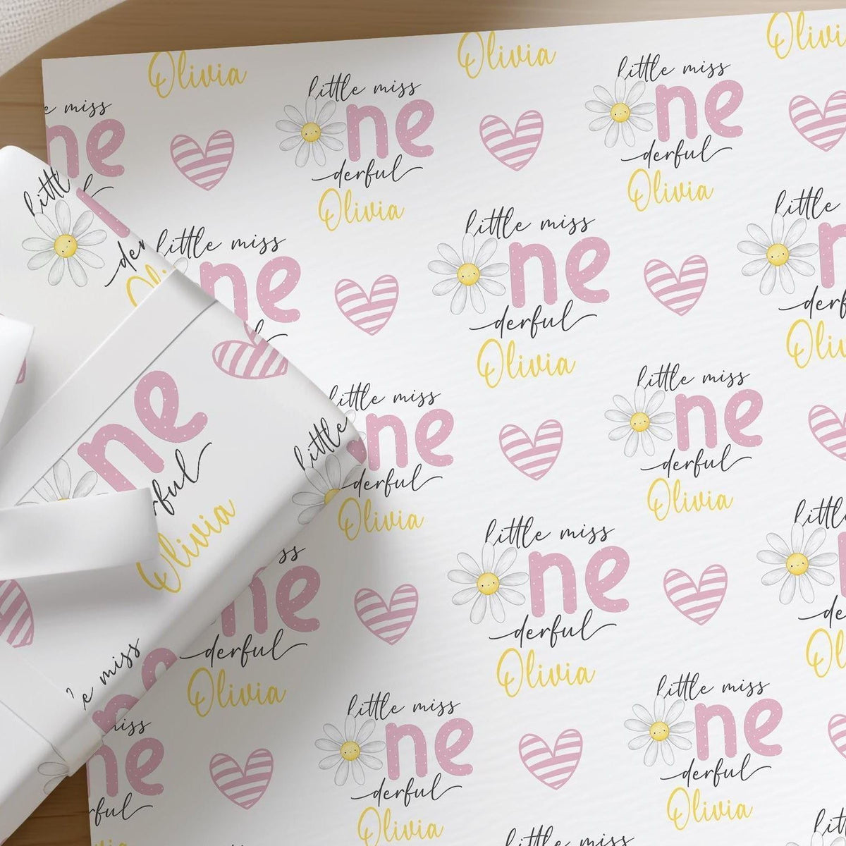 Roll of personalised daisy wrapping paper with an example name printed on the design