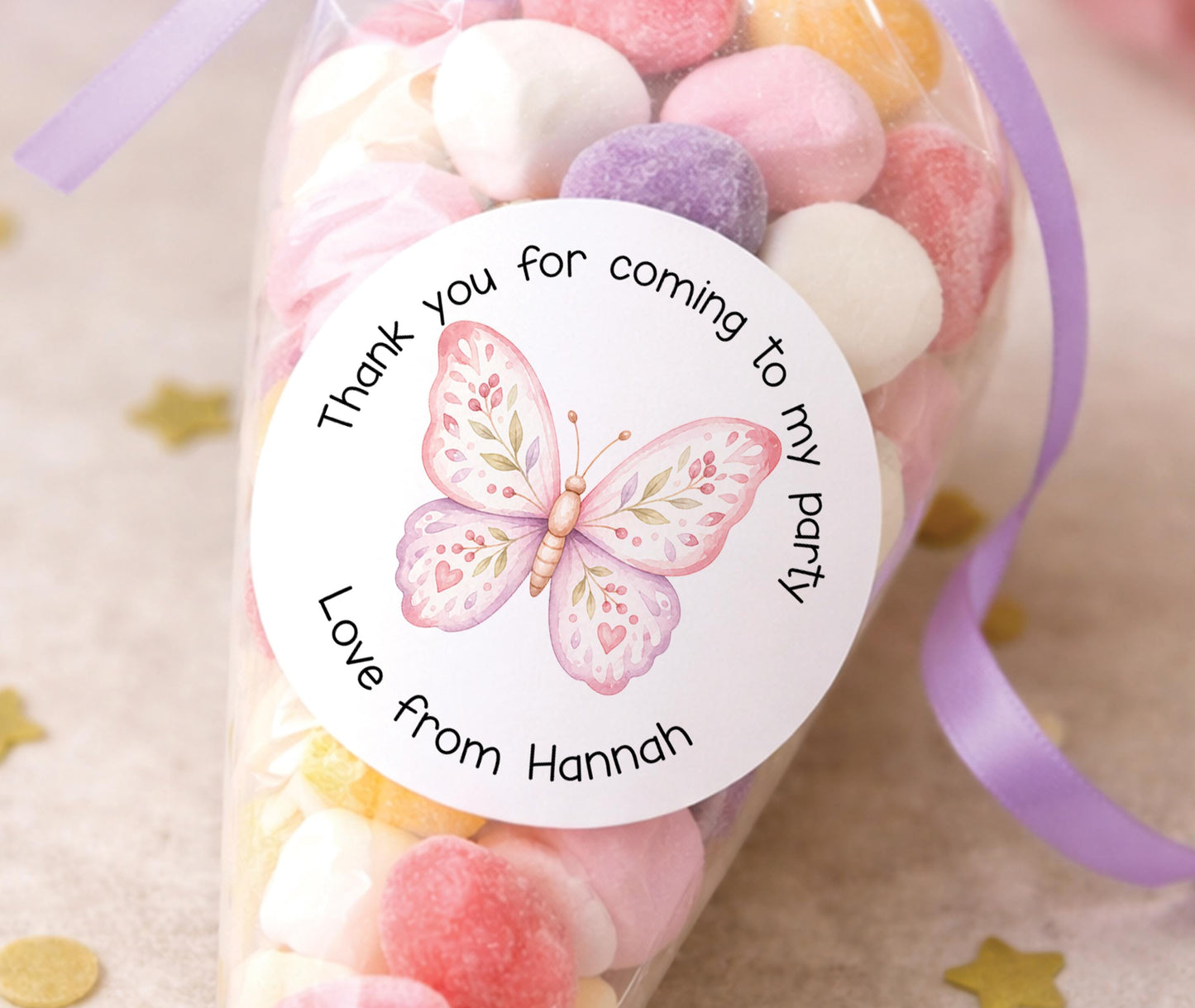 Personalised pastel pink butterfly stickers, printed with a child's name for party bag labels and favours.