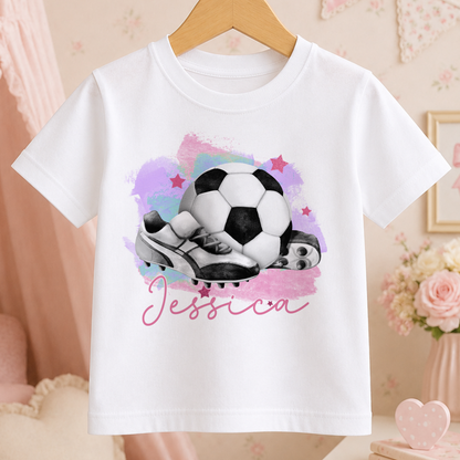 A white t-shirt with a printed design of a soccer ball and cleats, along with the name " Jessica" written below the image.