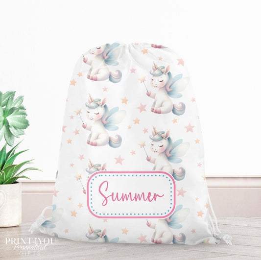 Personalised unicorn drawstring bag in pastel blush, peach and blue with fairy wings, wands and stars, printed with a custom child's name