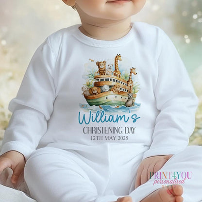 Personalised Noah's Ark christening outfit flat lay, customised with baby's name and date.