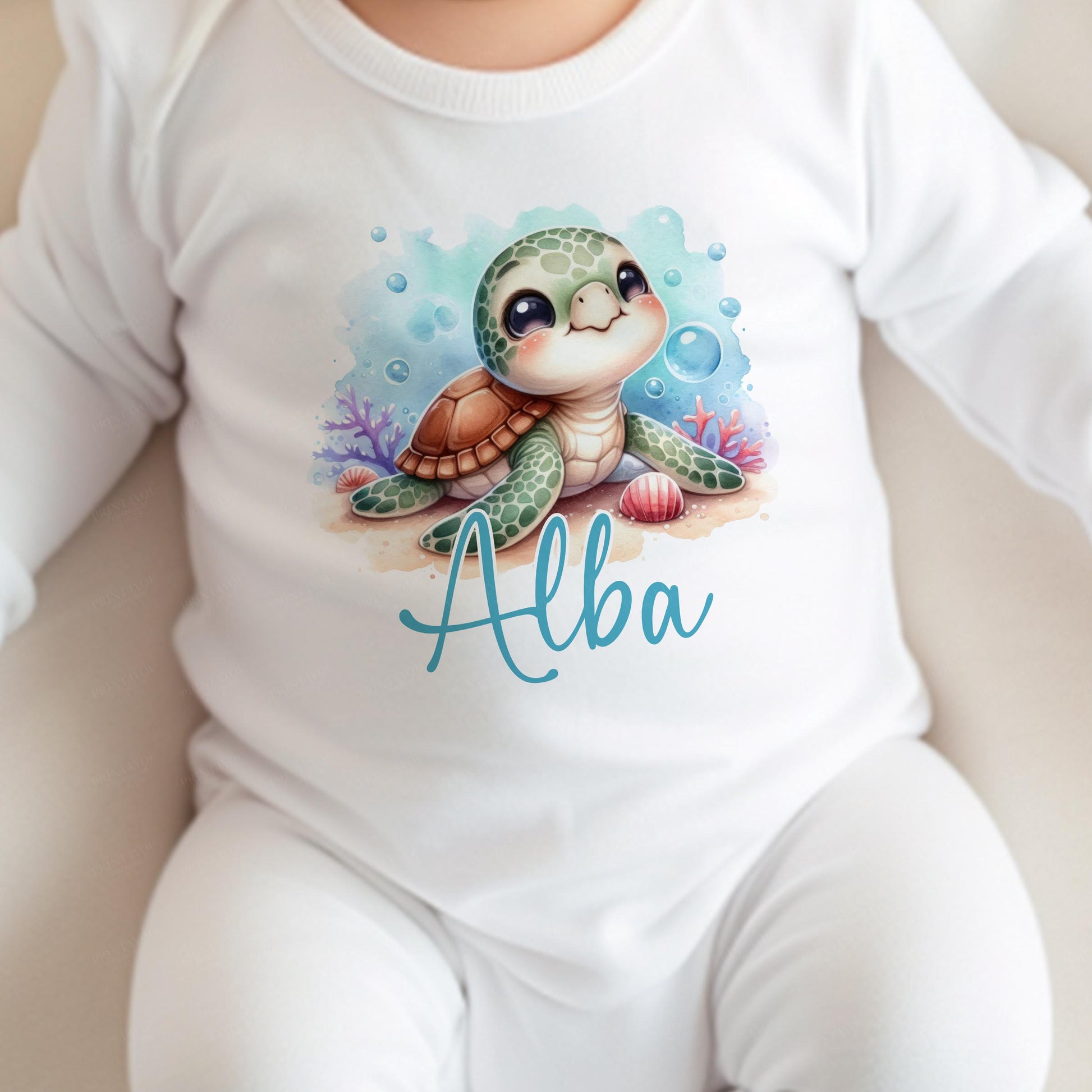 Close-up of the Sea Turtle print and personalised name detail on a baby vest.