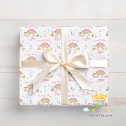 Close-up detail of personalised rainbow birthday wrapping paper showing the colourful rainbow pattern and custom text.