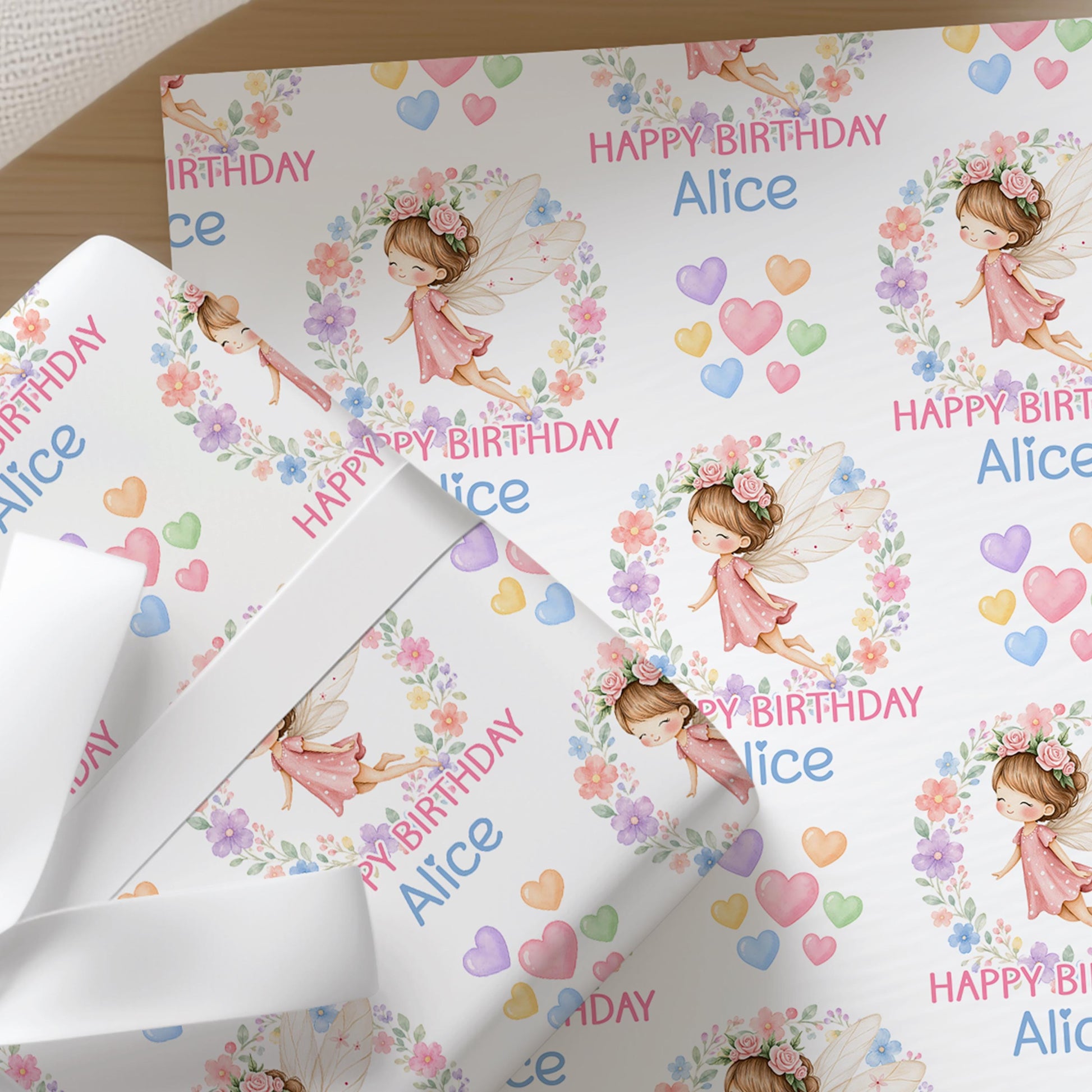 Personalised fairy wrapping paper shown wrapped around a gift box to demonstrate the finished look.