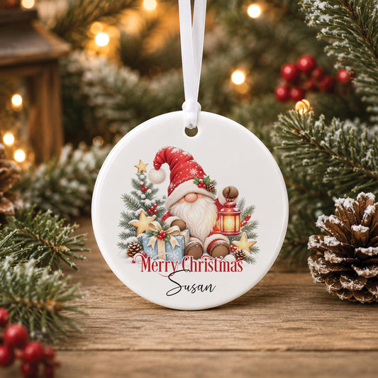 Personalised gnome Christmas bauble, white ceramic ornament with a Santa gonk holding a lantern, printed with Merry Christmas and a name