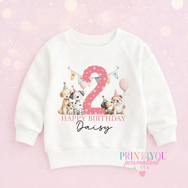 Personalised puppy birthday jumper laid flat, showing the puppy design and custom name print