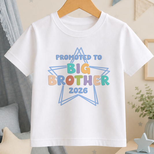 A white t-shirt with a colorful graphic design that says "Promoted to Big Brother 2026" printed on it.