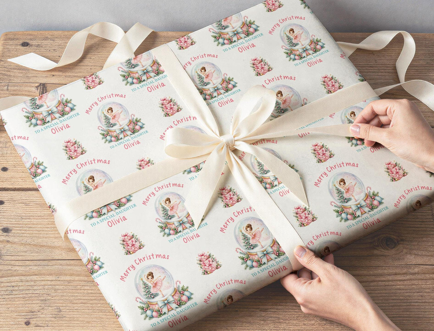 A gift wrapped in the personalised ballerina snow globe Christmas paper