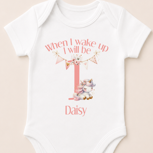 Personalised pink unicorn first birthday vest, printed with the 'When I Wake Up I Will Be One' design and baby's name.