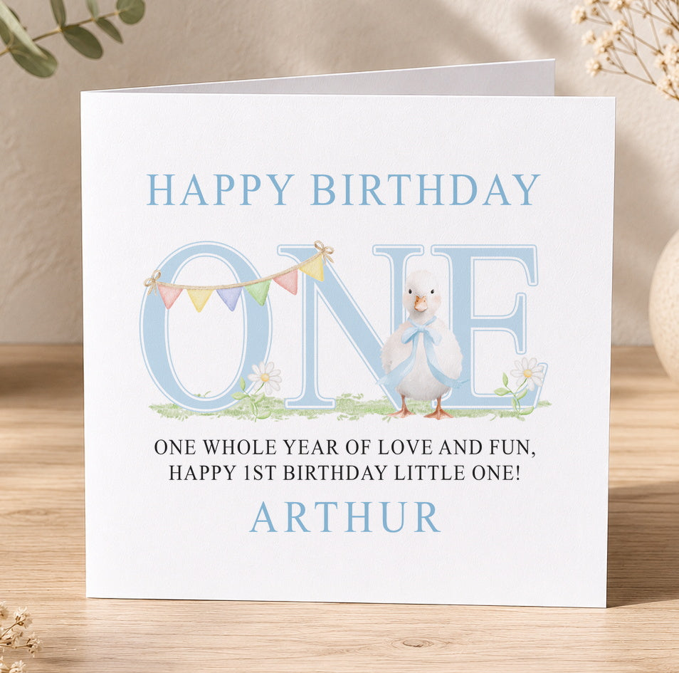 Square first birthday card for Arthur featuring an illustrated blue duck and colourful bunting flags.