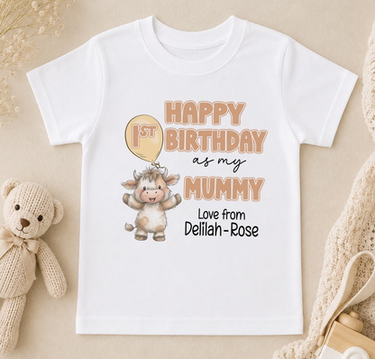 A white t-shirt with a birthday message for a baby, featuring a cartoon cow and the text "Happy 1st Birthday as my Mummy Love from Delilah - Rose".