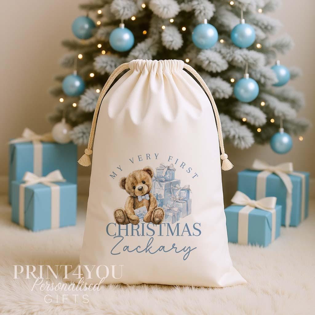 Personalised my first Christmas sack, cream cotton drawstring santa sack printed with a teddy bear and blue presents and My Very First Christmas with a name