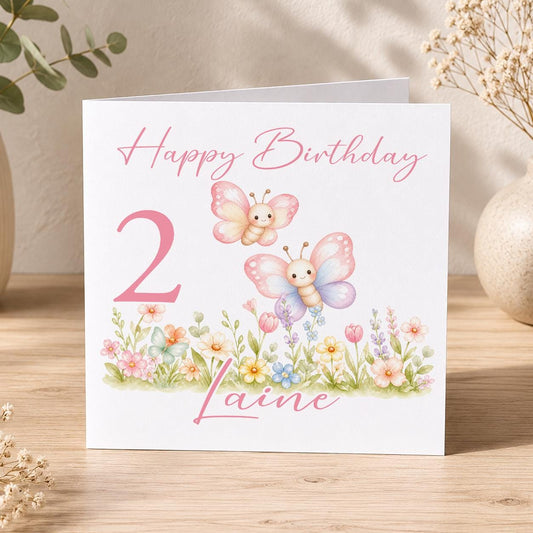 Square personalised birthday card featuring pink butterflies and floral details, with space for a printed name and age