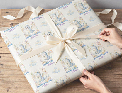 Gift wrapped in the personalised blue dragon baby wrapping paper, finished with ribbon