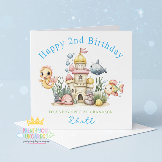 Front view of the personalised under the sea birthday card showing an ocean castle with seahorses and fish in a soft blue palette.