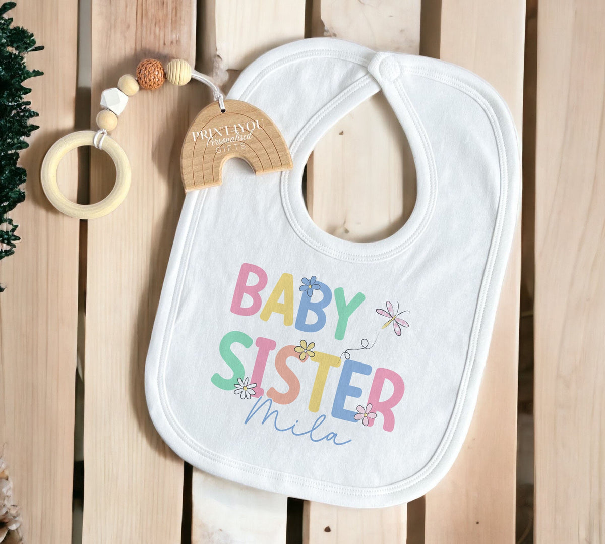 Close-up of the personalised baby sister text printed on soft cotton.