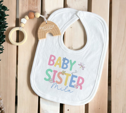 Close-up of the personalised baby sister text printed on soft cotton.
