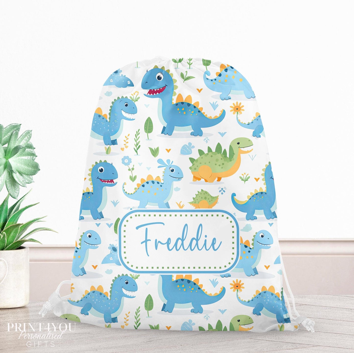 Personalised blue and green dinosaur drawstring PE bag with leafy accents, printed with a custom name on the front