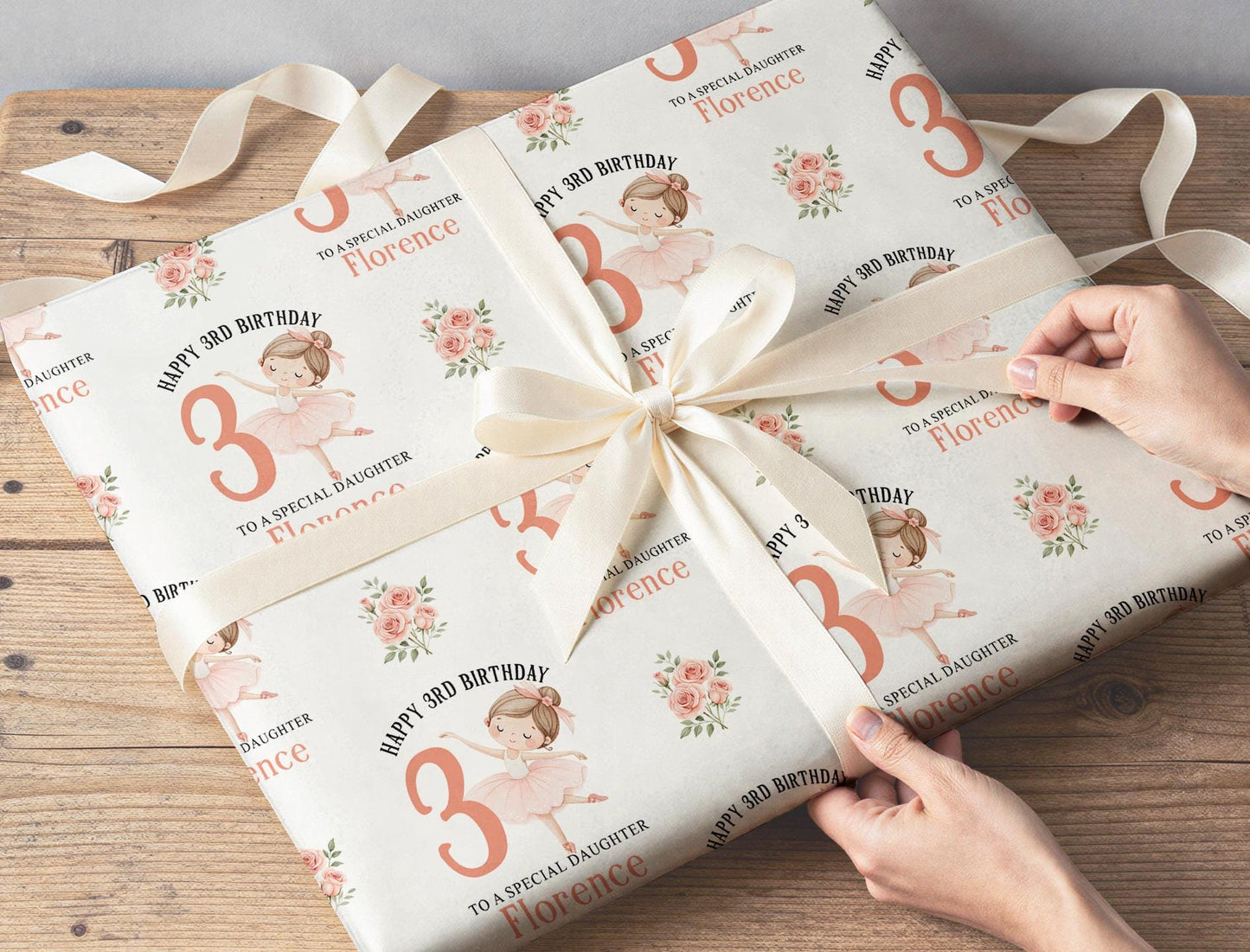 Personalised ballerina wrapping paper sheet laid flat showing the full repeating ballet dancer and floral pattern.