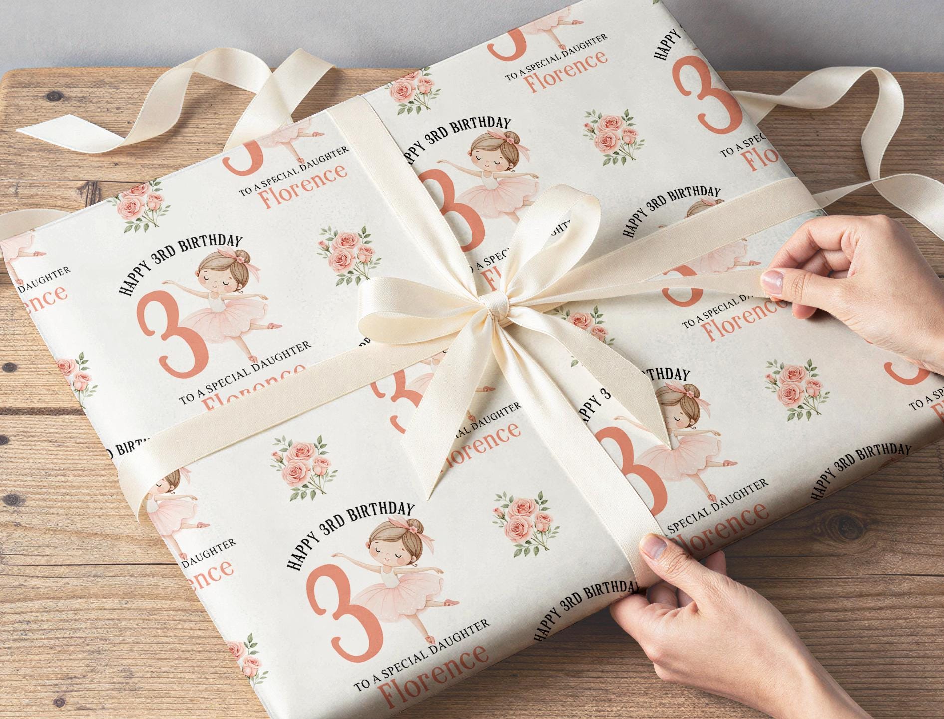 Personalised ballerina wrapping paper sheet laid flat showing the full repeating ballet dancer and floral pattern.
