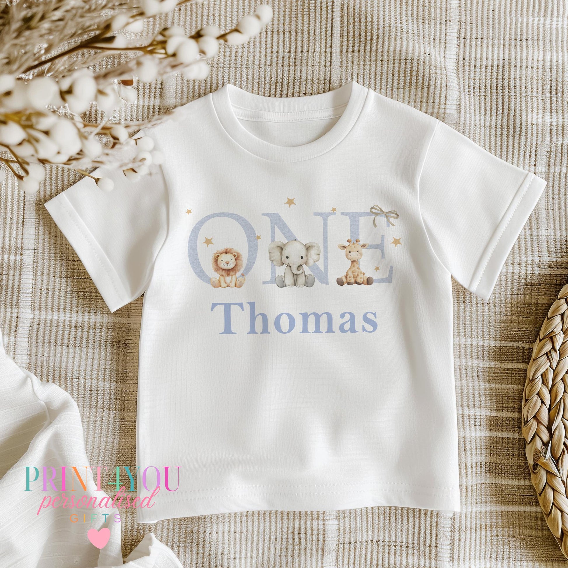 Close-up of the jungle safari first birthday design personalised with a child's name in pale blue script.