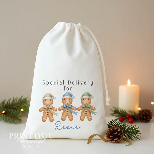 Personalised gingerbread Christmas sack, white A3 drawstring gift bag printed with three gingerbread men in blue hats and Special Delivery for a name