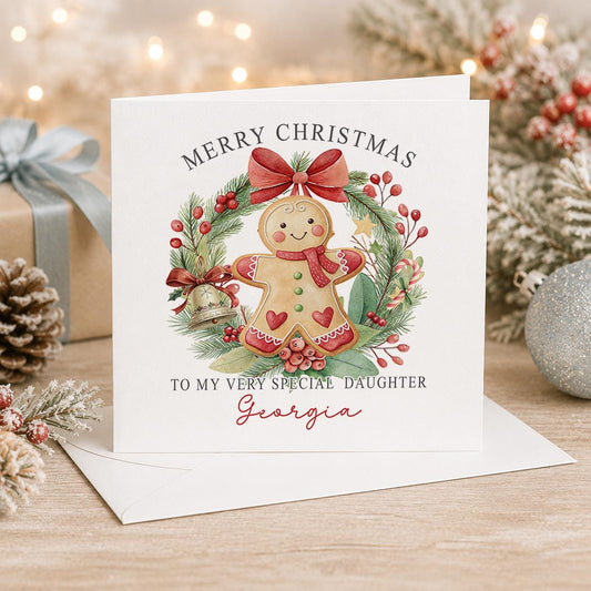 Personalised gingerbread Christmas card, white 6x6 inch square card printed with a gingerbread man in a holly wreath and a name