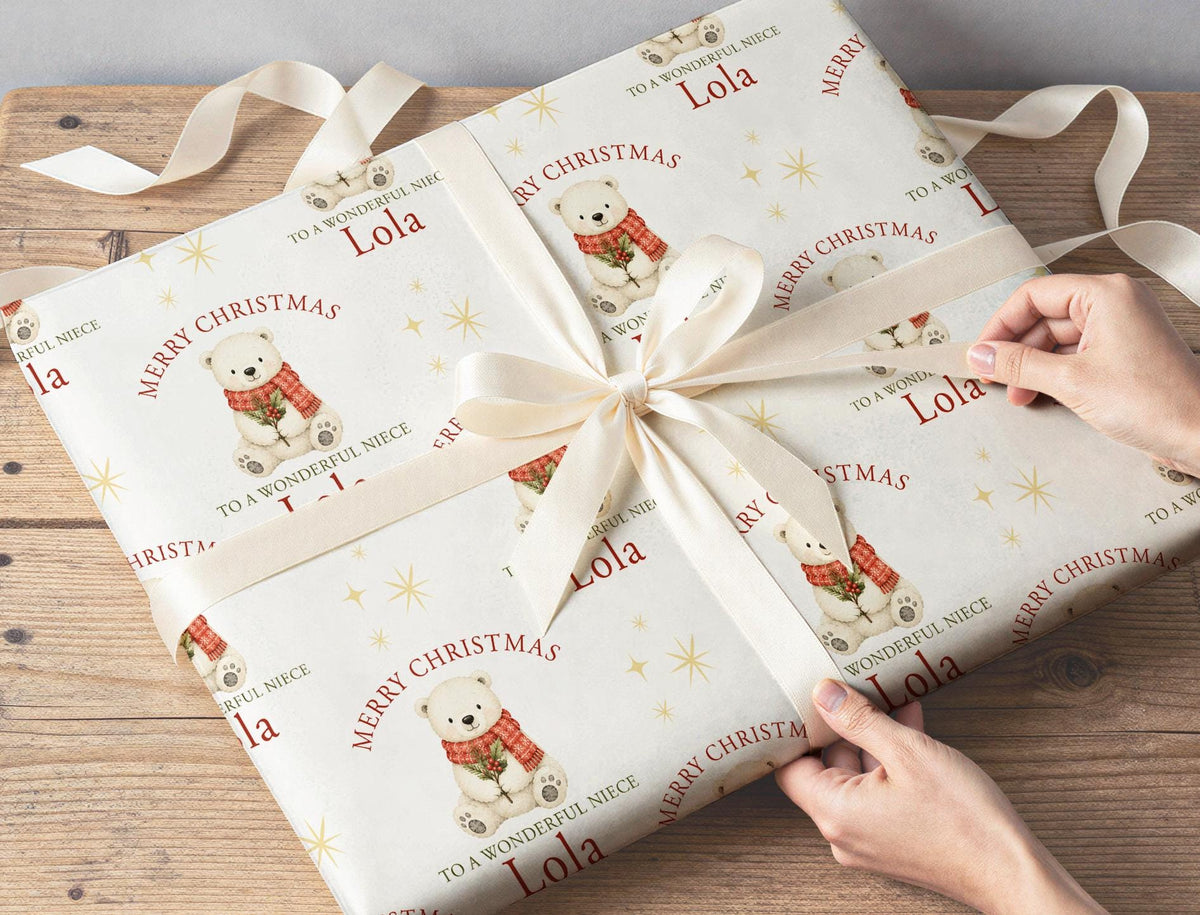 Personalised polar bear Christmas wrapping paper sheet laid flat showing the full repeating polar bear and holly pattern.