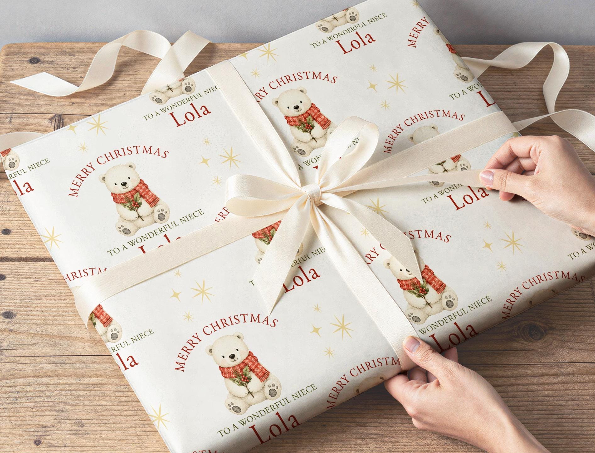 Personalised polar bear Christmas wrapping paper sheet laid flat showing the full repeating polar bear and holly pattern.