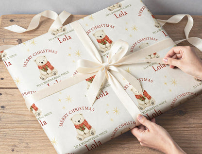 Personalised polar bear Christmas wrapping paper sheet laid flat showing the full repeating polar bear and holly pattern.
