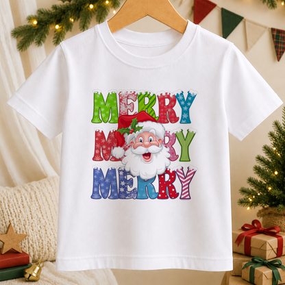 A white t-shirt with a colorful graphic design featuring a smiling Santa Claus wearing a red hat and surrounded by the text "MERRY MERRY MERRY" in a playful, festive style.