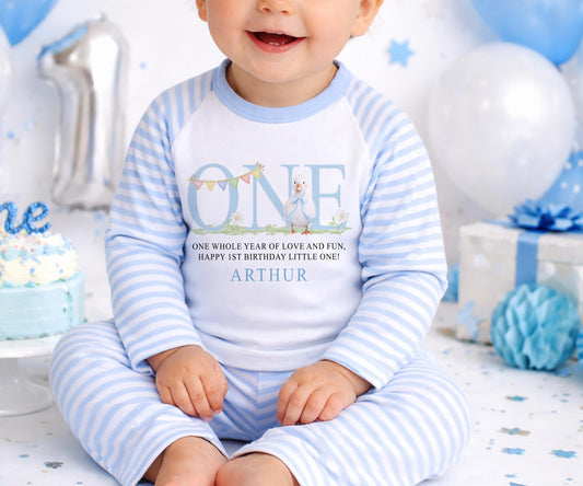 Personalised first birthday pyjamas with blue duck design and custom name, soft cotton