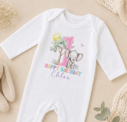 A white onesie with a printed image of an elephant and the text "Happy Birthday Chloe" printed on it.