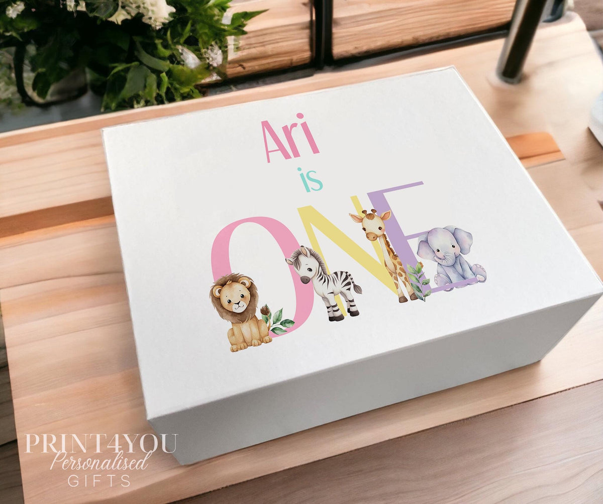 White magnetic-close keepsake box for a baby's first birthday, personalised with the child's name and printed with a pastel safari animal design, shown in the medium 160 x 200 x 80mm size