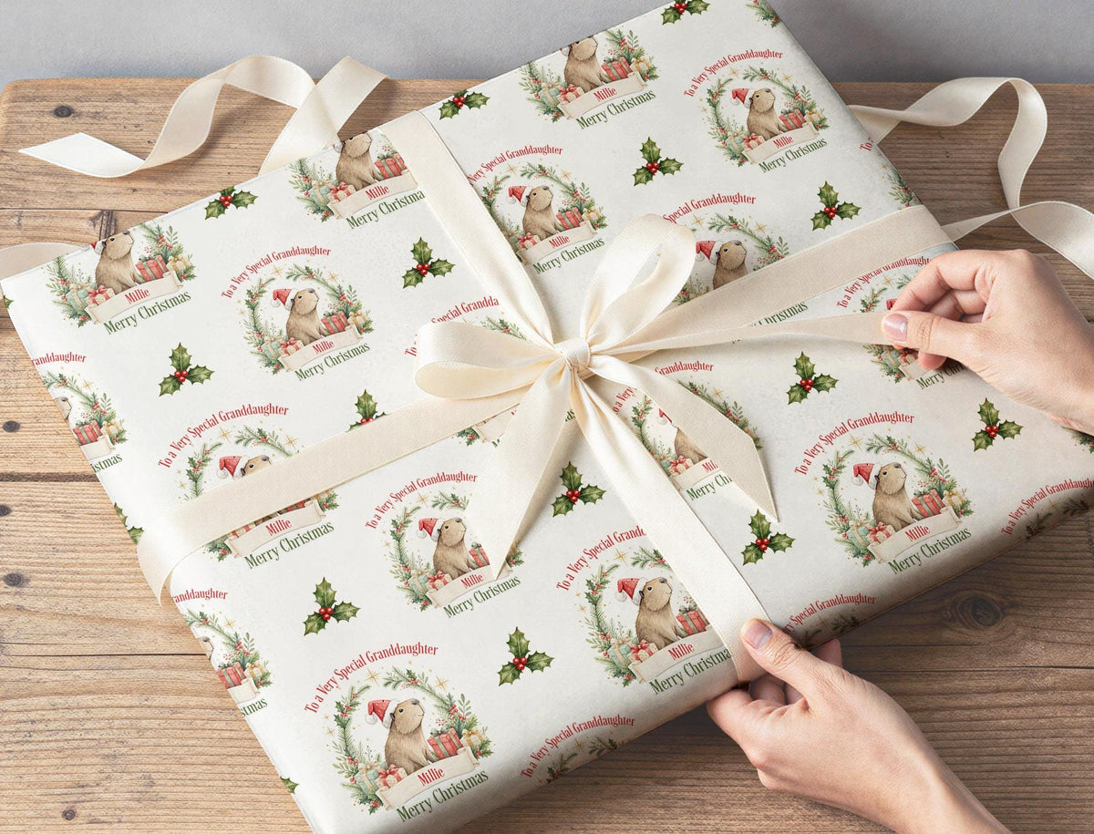 Gift being wrapped in the personalised custom name Christmas wrapping paper