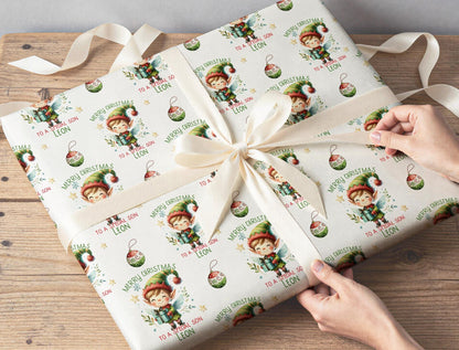 Personalised elf Christmas wrapping paper wrapped around a gift