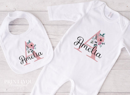 Personalised pink floral initial baby vest, printed with a custom name for a new baby.
