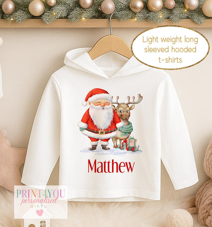 Personalised Christmas hooded t-shirt, white long sleeved hoodie printed with Santa holding a present with a reindeer and a name in red
