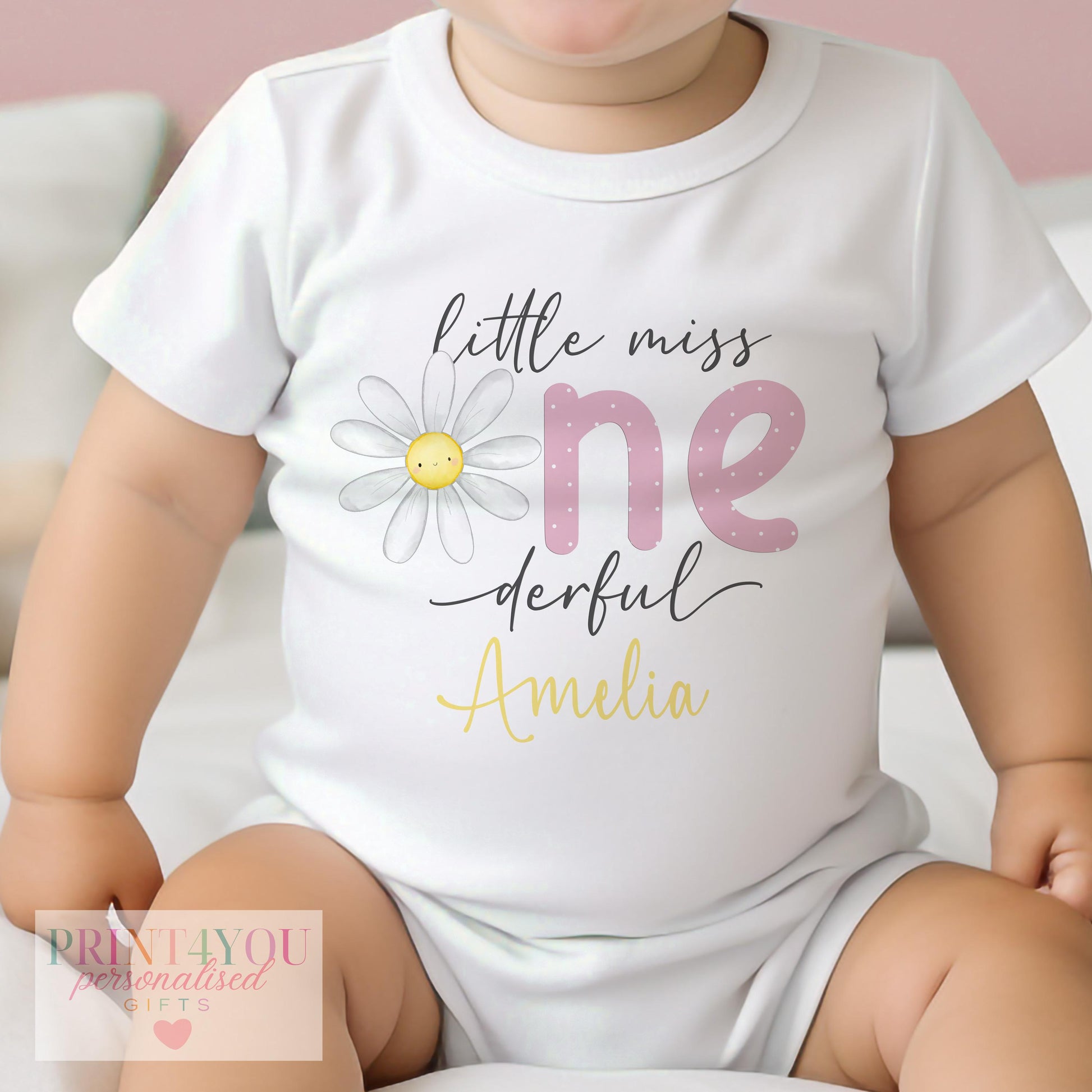 Personalised Little Miss One-derful daisy sleepsuit, shown with the golden yellow name print.