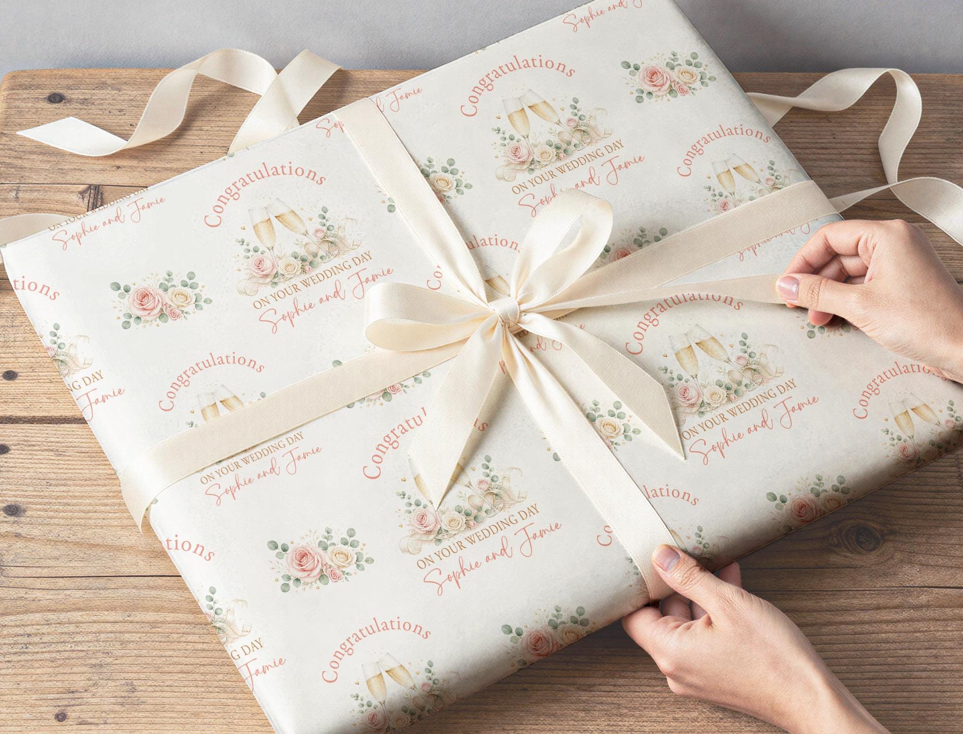 Wedding gift wrapped in personalised floral champagne wrapping paper with the couple's names