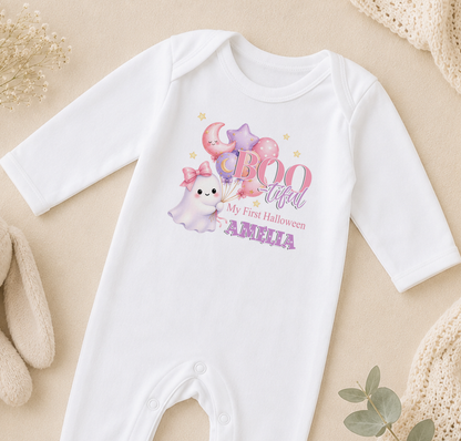A white onesie with a ghost and balloons printed on it, along with the text "My first Halloween" and "Amelia".