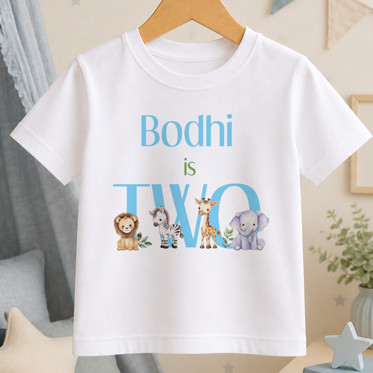 A white t-shirt with a personalized text and animal illustrations printed on it.