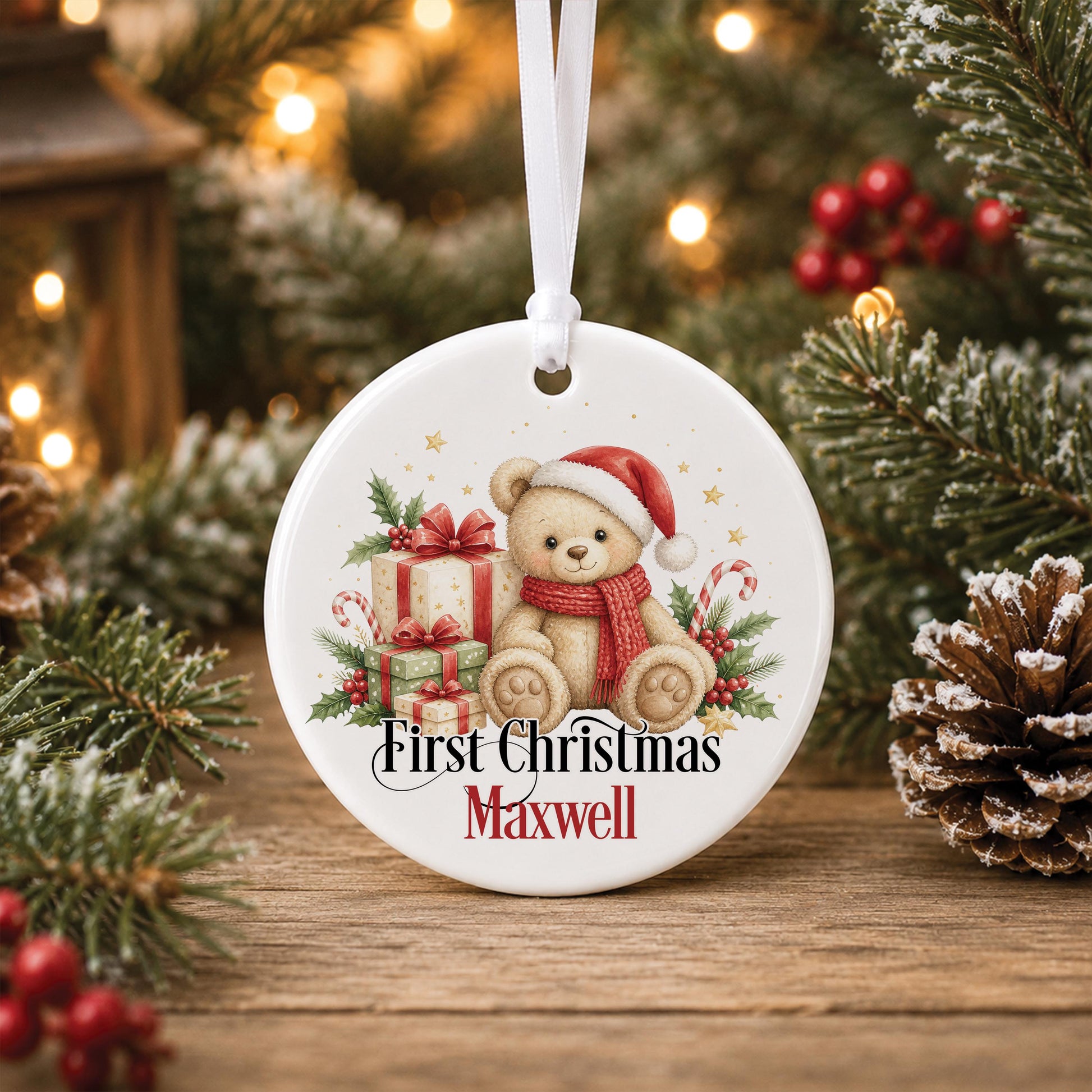 Personalised baby first Christmas bauble, white ceramic ornament with a teddy bear in a Santa hat and red presents, printed with First Christmas and a name