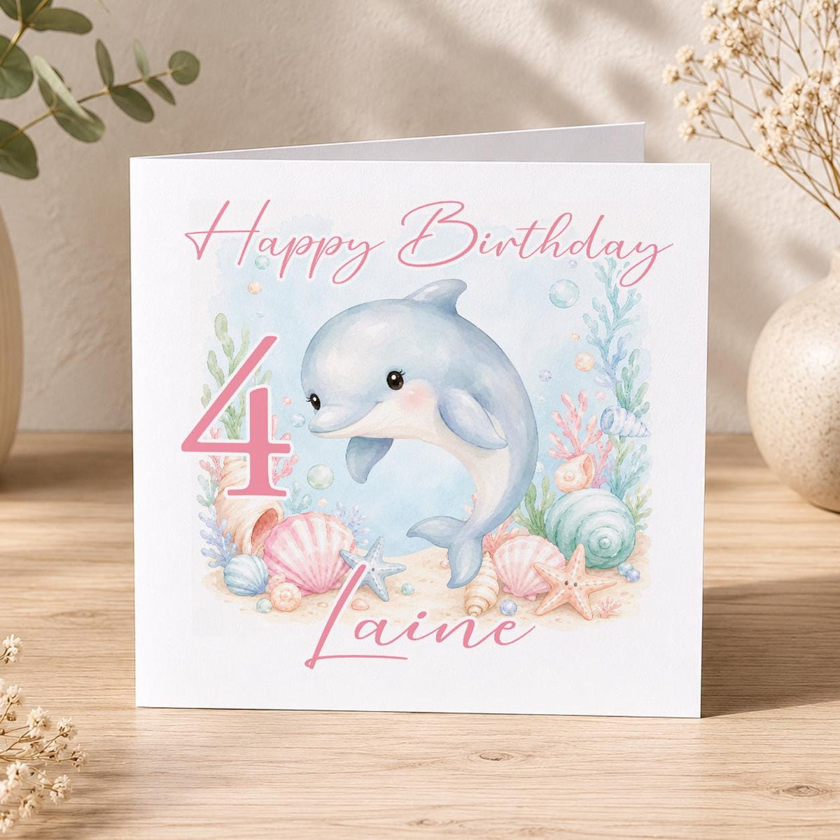 Square personalised birthday card featuring an ocean-themed dolphin design, personalised with the birthday child's name and age.